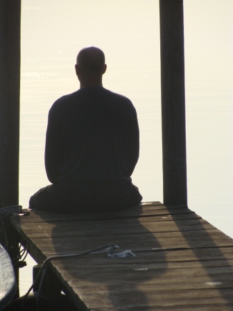 Thierry en méditation sur un ponton au bord du lac